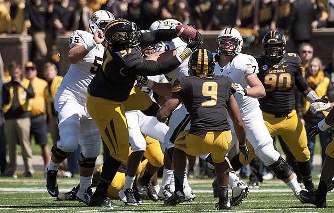 Missouri's Josh Augusta, center, pulls down an interception in a crowd of players during the third quarter of an NCAA college football game against Central Florida, Saturday, Sept. 13, 2014, in Columbia, Mo. 