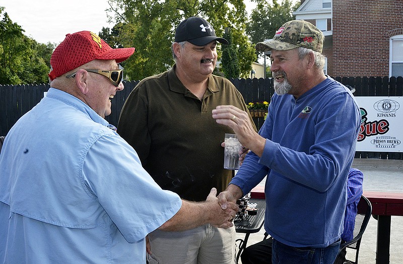 Willis Keeth, left, greets Charlie Wilson at Sunday's 10th annual reunion of Missouri State Penitentiary reunion. In the middle is Harlan Wayne Deardeuff. Today is the 10th anniversary of the closing of the old prison.