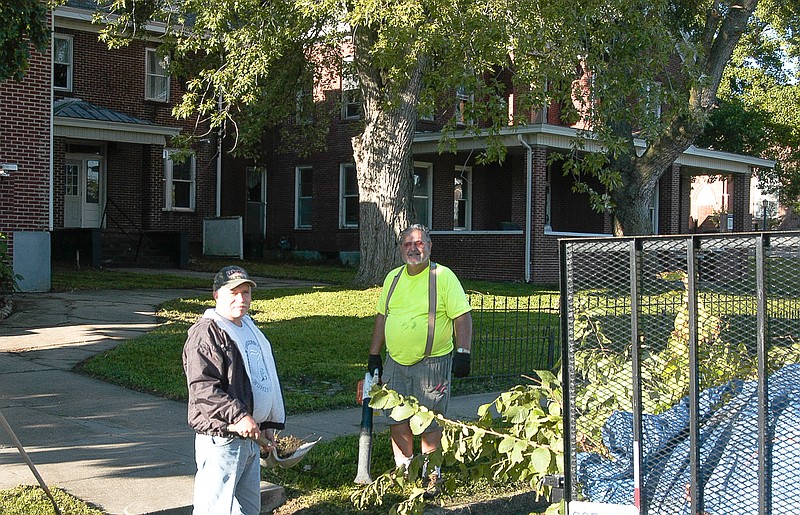 Two of many volunteers, Stuart Inglish and Charlie Roll, work on the cleanup of the grounds of the old Latham hospital to prepare for the Ozark Ham and Turkey Festival. The parade route is in front of the old building and the South Stage will be on the corner.