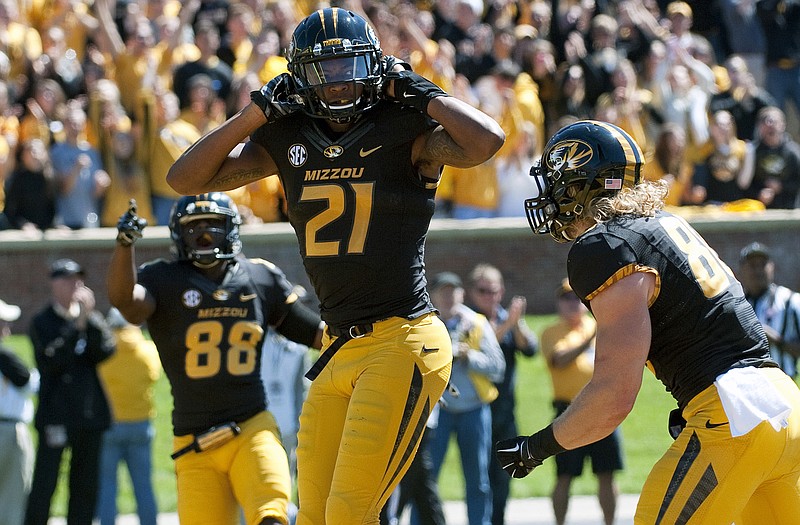 Missouri wide receiver Bud Sasser (center) celebrates with teammates Jimmie Hunt (left) and Sean Culkin after scoring on a 21-yard reception during the third quarter of Saturday's game against Central Florida at Faurot Field.