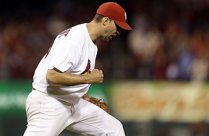 St. Louis Cardinals starting pitcher Adam Wainwright celebrates after throwing a complete baseball game against the Milwaukee Brewers, Wednesday, Sept. 17, 2014, in St. Louis. The Cardinals won 2-0.