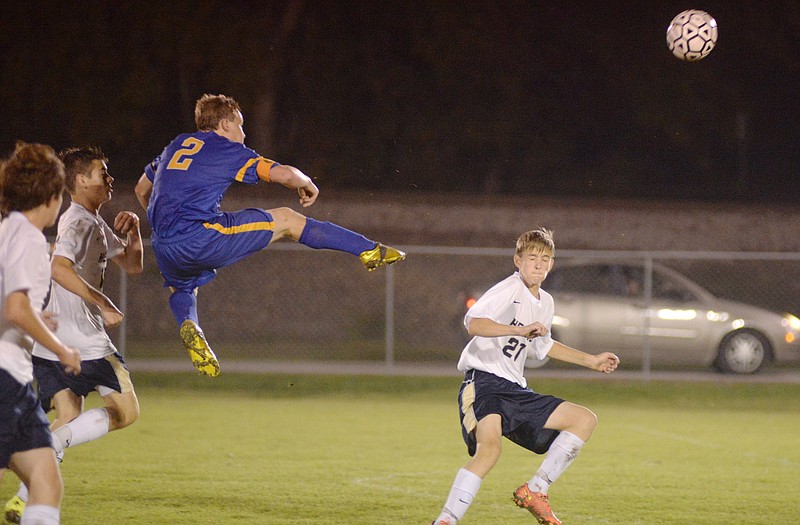 Fatima's Kaleb Bauer leaps in the air to take a shot at the goal near the end of the first half of Thursday's game at the 179 Soccer Park.