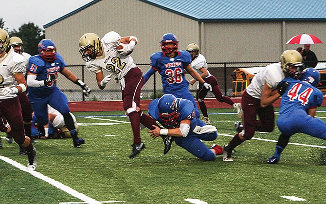 Eldon running back Levi Shinn is brought down by California's Sam Clenin in the first quarter of last Friday's game in California, Mo.