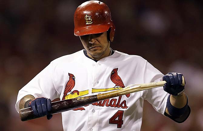 St. Louis Cardinals' Yadier Molina breaks his bat after flying out to end the third inning of a baseball game against the Cincinnati Reds Friday, Sept. 19, 2014, in St. Louis. 