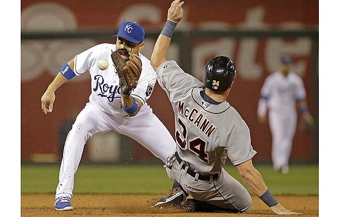 Detroit Tigers' James McCann (34) beats the tag by Kansas City Royals second baseman Omar Infante to steal second during the fourth inning of a baseball game Friday, Sept. 19, 2014, in Kansas City, Mo.