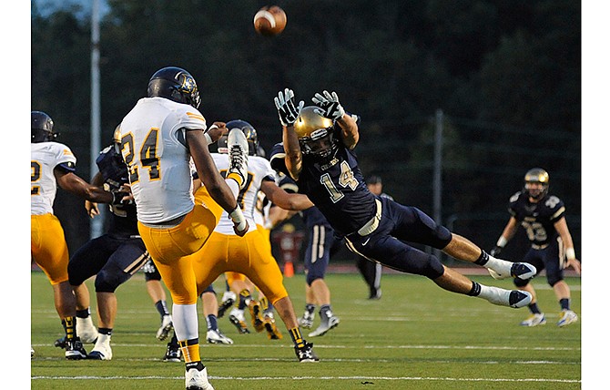 Helias' Todd Buschjost narrowly misses blocking a Battle punt during the first quarter of Saturday night's game at Adkins Stadium.