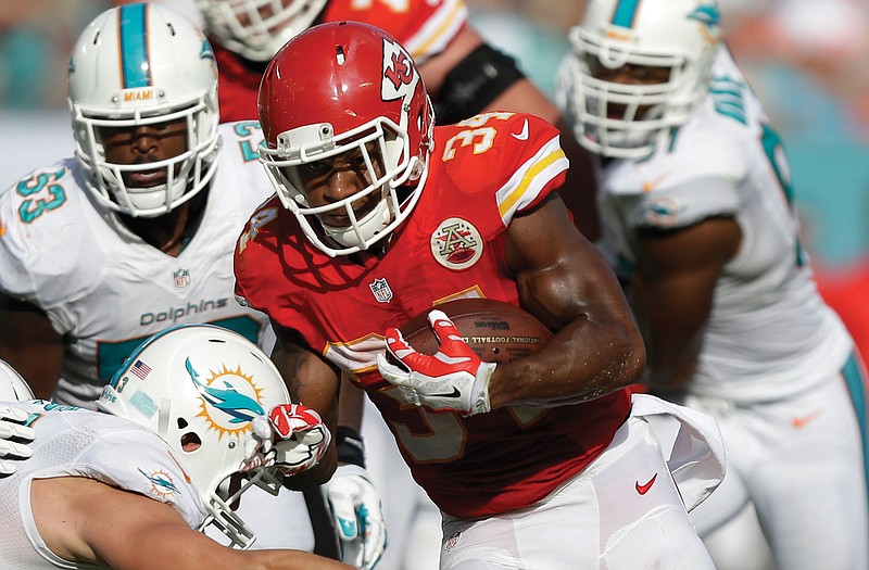 Chiefs running back Knile Davis avoids a tackle from Dolphins outside linebacker Jason Trusnik as he runs for a touchdown during the first half of Sunday's game in Miami Gardens, Fla. 