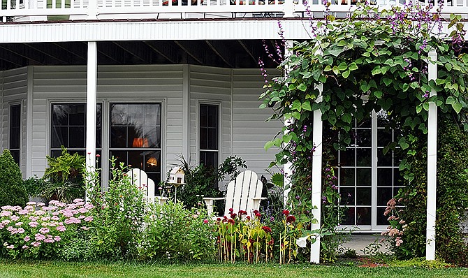 The backside of the Cummins' house features a number of plantings, including sedum, cockscomb and the hyacinth bean-covered arbor.