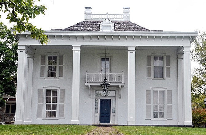 The original builder abandoned the Vineyard Place before exterior work was complete in the 1840s. When Nick and the late Mildred Monaco bought the Jefferson City home, they discovered the original plat book in the basement and completed the original architect's vision, including the front portico and columns and the widow's walk atop the mansion in the 1960s.