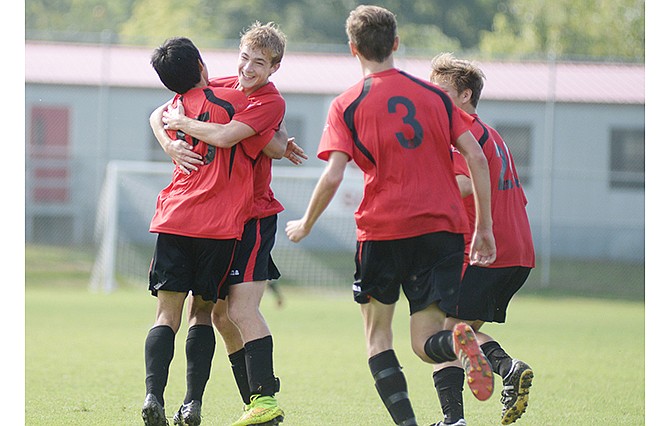 
Jefferson City's Spencer Bone (second from left) celebrates with teammates after scoring one of his two goals in the Jays' 3-0 win against Poplar Bluff on Saturday in the Capital City Invitational at the 179 Soccer Park.