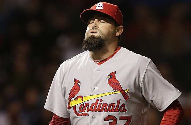 St. Louis Cardinals relief pitcher Pat Neshek exhales after retiring the side during the ninth inning of a baseball game against the Chicago Cubs on Tuesday, Sept. 23, 2014, in Chicago. 