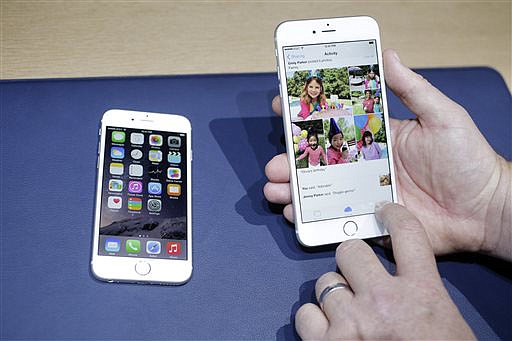 The iPhone 6, at left, and iPhone 6 plus are shown next to each other during a new product release in Cupertino, California. Apple's new and bigger iPhone 6 and iPhone 6 Plus are more durable than last year's model and a leading Android phone, a study says.