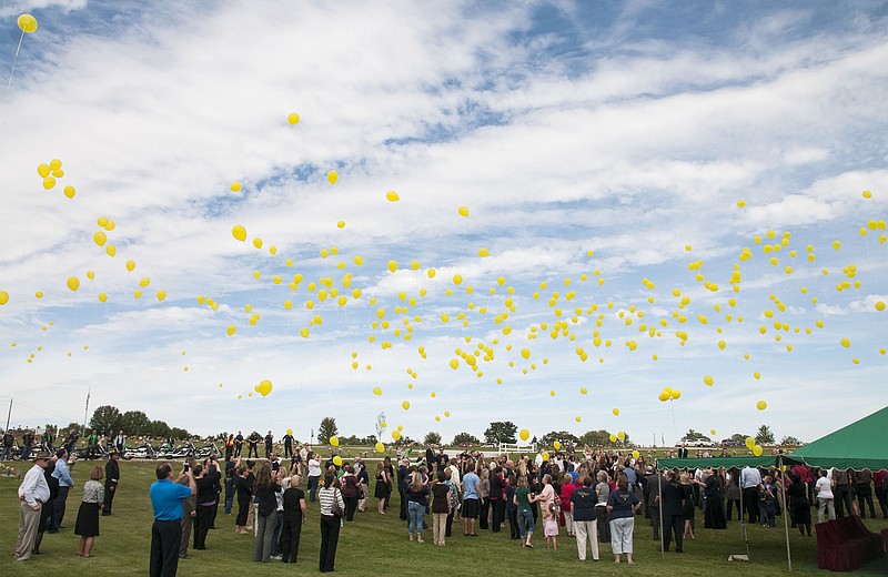 Hundreds of yellow balloons float into the sky in honor of "Super" Sam Santhuff, a 6-year-old Fulton boy who recently passed away from cancer, to conclude his funeral Wednesday at Memorial Gardens. Through his hard fought 13-month cancer battle, "Super" Sam became a hero to many in the Callaway County community and far beyond. The balloon release was a tribute to Sam. His mother, Cassie Santhuff, said it was a way to show Sam in heaven how much he is still loved. It also acted as an awareness event for childhood cancer awareness, which color is yellow and month is September. Cassie and Sam talked about hosting awareness campaigns and informing the public about childhood cancer statistics to promote awareness.