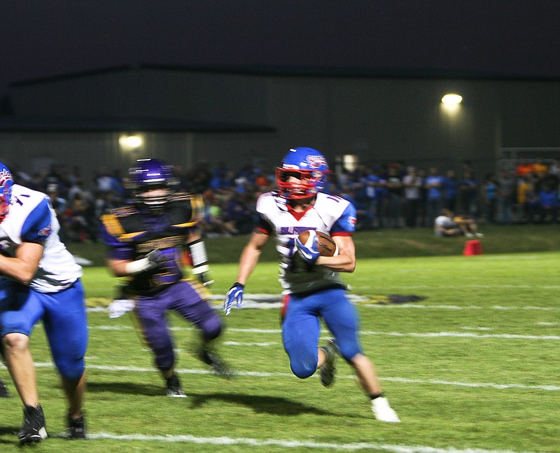 California's Walker Borghardt stomps into the end zone after scoring a 19-yard touchdown with 2:34 remaining in the first half of the Pintos' conference game at Hallsville Friday night. California won 68-14.