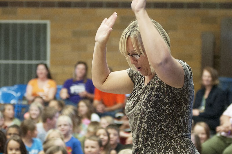 Bartley Elementary first grade teacher Amy Totta celebrates her raffle win of a Walmart gift card on Thursday during an assembly.