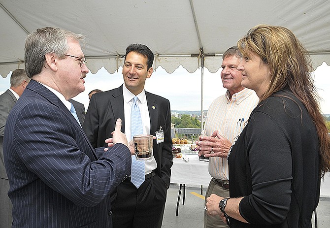 Sam Bushman, left, Dr. Teri Deffenbaugh, right, and Mike Bates visit with Gaspare Calvaruso, second from left, Capital Region Medical Center's new president. Bushman is on the board of directors of the hospital and Deffenbaugh is with CRMC's OB/GYN Associates.