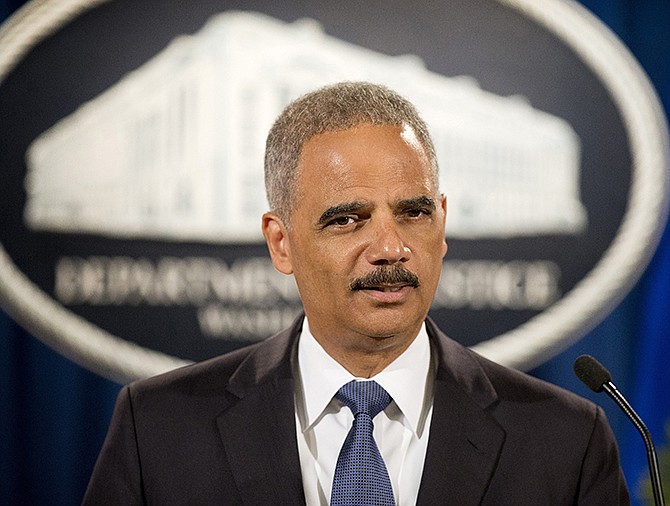 In this September 2014 photo, Attorney General Eric Holder speaks during a news conference at the Justice Department in Washington. A White House official says Attorney General Eric Holder is resigning. 