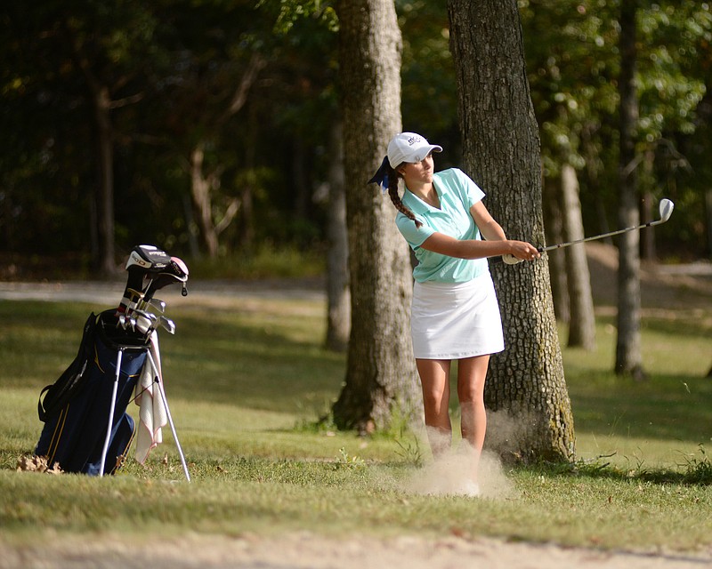 Jenna Kosmatka of Helias hits a chip shot during Thursday's triangular against Russellville, California and Eugene at the Oak Hills Golf Center.