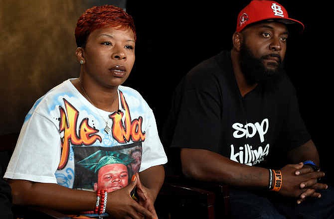 The parents of Michael Brown, Lesley McSpadden, left, and Michael Brown, Sr., right, speak to The Associated Press during an interview in Washington, Saturday, Sept. 27, 2014. Michael Brown's parents say they are unmoved by the Ferguson police chief's apology in their son's shooting death by a police officer. Instead, Lesley McSpadden and Michael Brown Sr. told The Associated Press they would rather see an arrest, and Brown Sr. said he wants the police officer "in handcuffs."