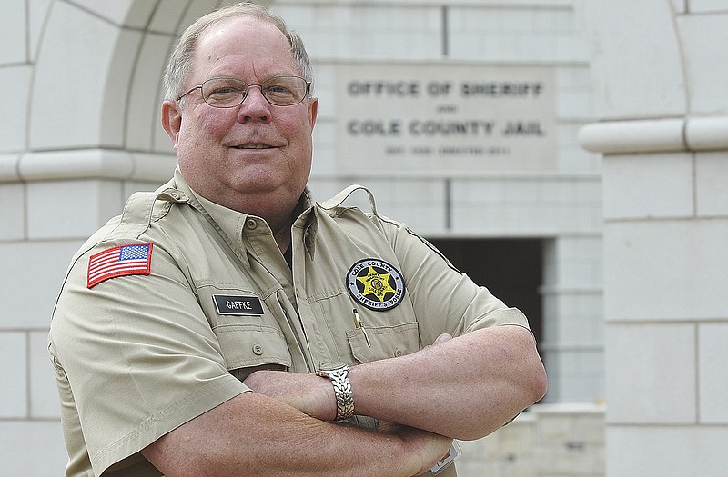 Always with a smile is Greg Gaffke, wearing a uniform of the Cole County Sheriff's Posse, one of the numerous volunteer duties he holds.