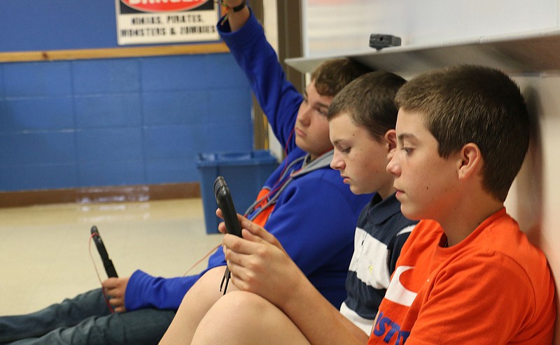 Students in Tim Rickerson's eighth grade communication arts class work on a class assignment on their iPads Monday afternoon.