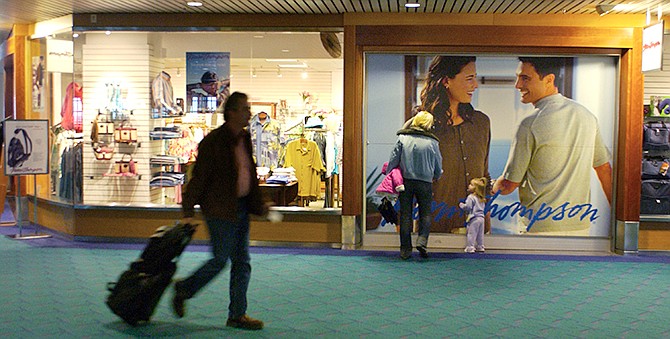In this 2006 photo, airport passengers pass by Norm Thompson retail outlet at Portland International Airport in Portland. The Federal Trade Commission announced this week that two companies have agreed to refund $1.5 million to consumers who purchased "shapewear" that supposedly can reduce cellulite and fat because it's infused with caffeine, vitamin E and other things. In a settlement, Norm Thompson Outfitters of Oregon, and Wacoal America Inc. of New Jersey agree not to make claims that their products cause weight loss or a reduction of body size. 