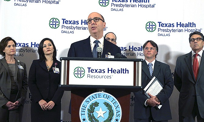 Dr. Mark Lester, front center, speaks during a news conference at Texas Health Presbyterian Hospital Dallas, Wednesday. Lester confirmed that a nurse asked an infected Ebola patience on his first visit to the hospital whether he had been in an area affected by the Ebola outbreak that has killed thousands in West Africa, but that "information was not fully communicated throughout the whole team." 