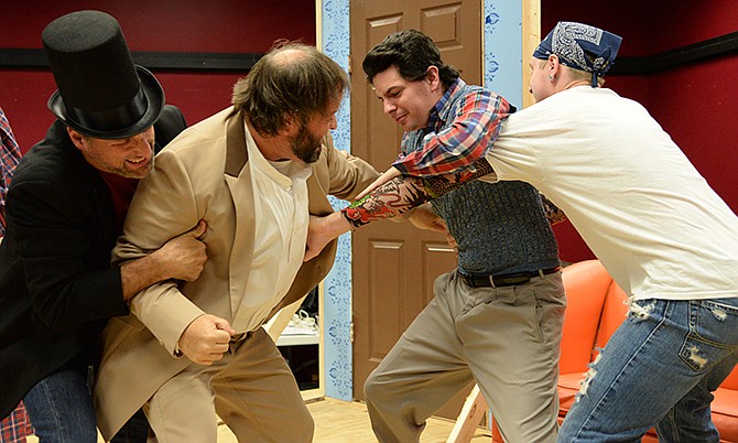 The cast of "Inspecting Carol" rehearse a scene in which two of the characters, Wayne and Phil, get into an argument over the roles they play in the play "A Christmas Carol." From left, Brian Happer plays Larry Vauxhall, John Wells plays Phil Heulitt, Drew Reynolds plays Wayne Wellacre and Grant Borland plays Bart Francis. 