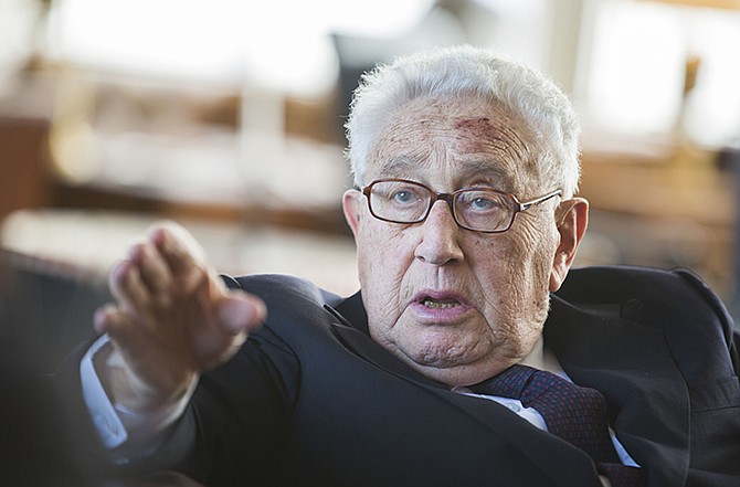 In a 2013 photo, former US Secretary of State Henry Kissinger gestures during a reception for his 90th birthday in Berlin, Germany. According to declassified government documents posted online Wednesday, Kissinger ordered contingency plans drawn up nearly 40 years ago to attack Cuba, incensed over the small island's deployment of troops to Angola.