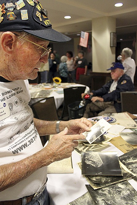 World War II veteran Dale Stickrath tries to remember the date of a photograph during a reunion for the famed 307th Bombardment Group in Santa Fe, New Mexico. A few remaining members of the 13th Air Force's famous 307th Bombardment Group, their family members and Ancestry.com's military records site Fold3 are working to keep alive the group's memory by collecting and digitizing thousands of photographs, military orders and other memorabilia. The records are being posted online as part of a searchable database. 