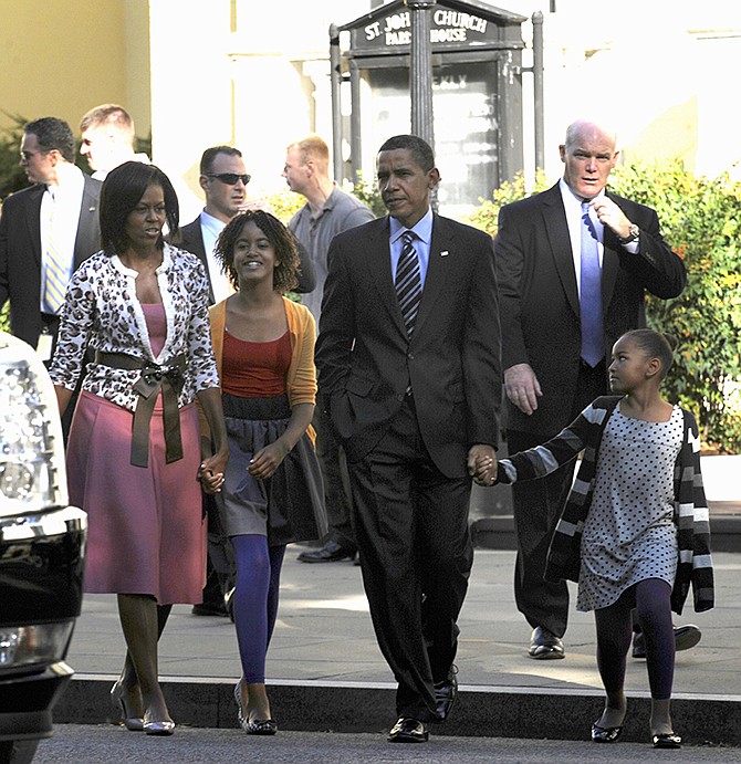In this 2009 photo, Secret Service Agent Joseph Clancy, right, walks behind President Barack Obama, first lady Michelle Obama and their, children Sasha, right, and Malia, second from left, walking back to the White House after attending St. John's Episcopal Church in Washington. Clancy has been named interim director of the Secret Service. 
