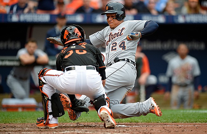 Baltimore Orioles catcher Caleb Joseph tags out Detroit Tigers' Miguel Cabrera at home plate on Detroit Tigers designated hitter Victor Martinez's double in the eighth inning of Game 2 in baseball's AL Division Series in Baltimore, Friday, Oct. 3, 2014. Baltimore won 7-6. 
