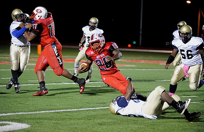 Jefferson City Jay Denzel Wilson is tripped up as he makes some yardage during Friday's game against Confluence Prepratory Academy at Adkins Stadium. 