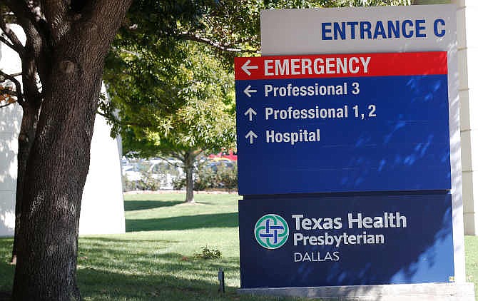 A sign marks Entrance C at Texas Health Presbyterian Hospital Friday, Oct. 3, 2014, in Dallas, where Thomas Eric Duncan, the Ebola patient who traveled from Liberia to Dallas last week, is being treated. 