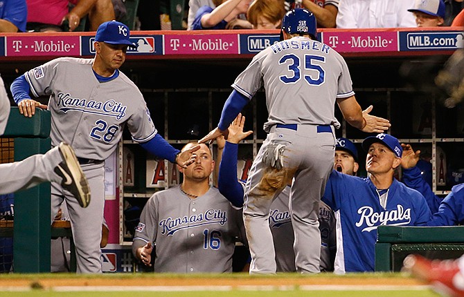 Kansas City Royals Eric Hosmer (35) is greeted in the dugout after he scored on a single by Alex Gordon against the Los Angeles Angels in the second inning of Game 2 of baseball's AL Division Series, in Anaheim, Calif., Friday, Oct. 3, 2014.