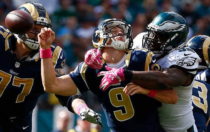 Philadelphia Eagles' Trent Cole, right, knocks the ball loose from St. Louis Rams' Austin Davis (9) during the second half of an NFL football game, Sunday, Oct. 5, 2014, in Philadelphia. Philadelphia recovered the fumble and scored on the play. 