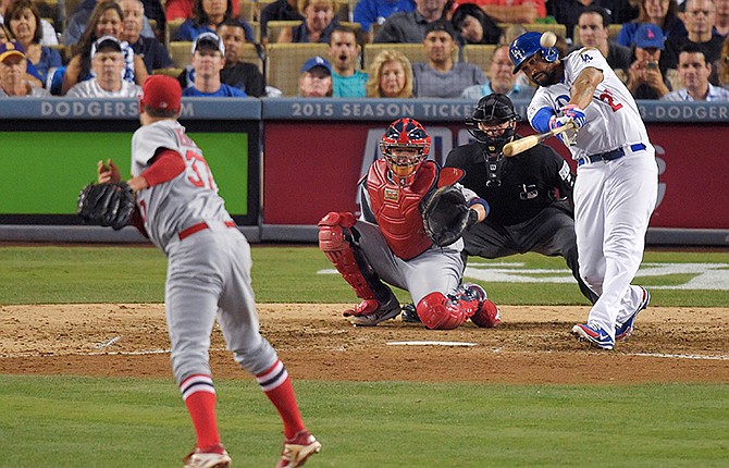 Los Angeles Dodgers' Matt Kemp hits a home run off St. Louis Cardinals relief pitcher Pat Neshek during the eighth inning in Game 2 of baseball's NL Division Series in Los Angeles, Saturday, Oct. 4, 2014.