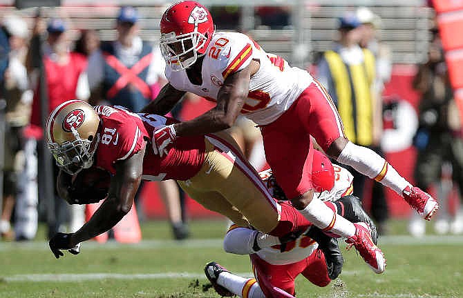 San Francisco 49ers wide receiver Anquan Boldin (81) is tackled by Kansas City Chiefs cornerback Chris Owens (20) and defensive back Ron Parker during the second quarter of an NFL football game in Santa Clara, Calif., Sunday, Oct. 5, 2014. (