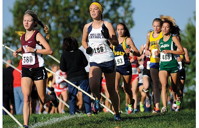 Helias' Kaitlyn Shea keeps pace with the race leaders while running near the front of the field in the early stages of the girls Class 3 and 4 varsity event during Saturday's Capital City Cross Country Challenge at Oak Hills Golf Center. Shea finished in the top spot for Class 3 with a time of 19:34.55.