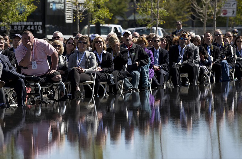 Veterans and invited guests listen to President Barack Obama speak Sunday at the American Veterans Disabled for Life Memorial dedication ceremony. Obama paid tribute to disabled U.S. veterans on Sunday, pointing to the dedication of a new memorial honoring those severely injured in war as a symbol of the nation's perseverance and character. 
