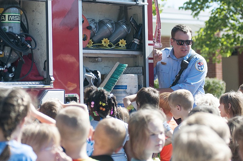 Todd Pritchett, engineer with the Fulton Fire Department, shows Bush Elementary School kindergarten students items stored inside a firetruck on Tuesday.