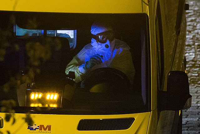 An ambulance transporting a Spanish nurse who believed to have contracted the ebola virus from a 69-year-old Spanish priest leaves Alcorcon Hospital in Madrid, Spain, Tuesday. The nurse who treated a missionary, posted in Sierra Leone, for the disease at a Madrid hospital tested positive for the virus, Spain's health minister said Monday.