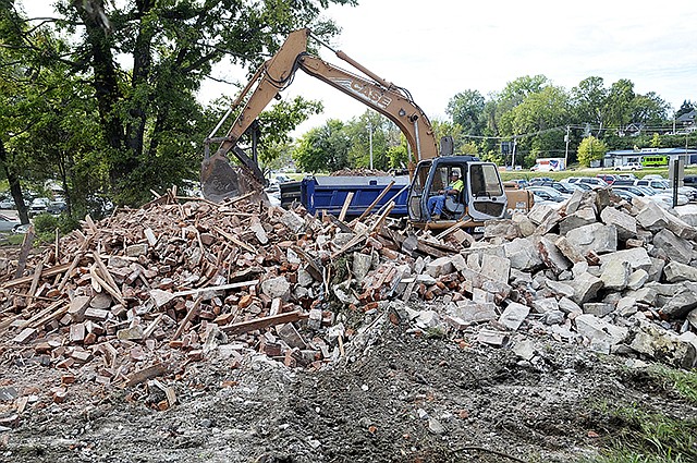 Jack Walker of Kauffman Enterprises operates the track hoe to remove the rubble from the next to last building standing in the 200 block W. McCarty Street. They started the demolition Saturday and are nearly finished with the job.