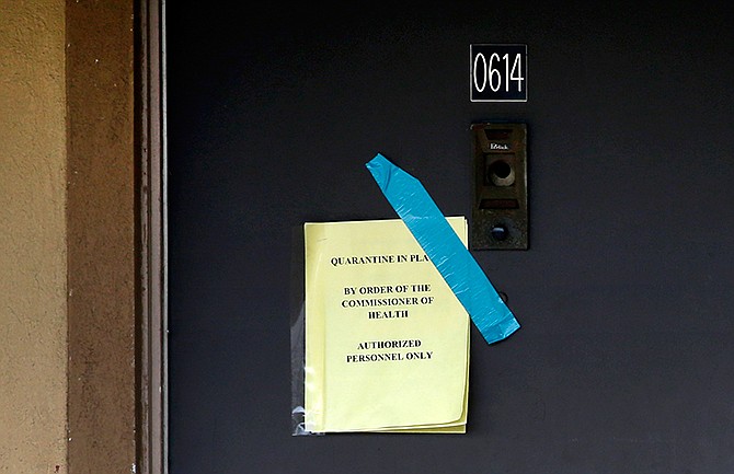 A sign on the door of the apartment where Thomas Eric Duncan stayed with family warns that the unit has been quarantined by the commissioner of health, Wednesday, Oct. 8, 2014, in Dallas. Texas Health Presbyterian Hospital Dallas, where Duncan was being treated for Ebola, said that Duncan has died. The apartment was stripped bare, including the blinds that used to hang in the winds.