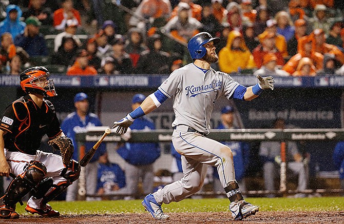 Kansas City Royals' Alex Gordon (4) watches his solo home run during the 10th inning of Game 1 of the American League baseball championship series against the Baltimore Orioles Saturday, Oct. 11, 2014, in Baltimore.