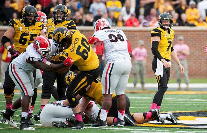Missouri quarterback Maty Mauk, right, watches the action as his fumble is recovered by Georgia during the second quarter of an NCAA college football game Saturday, Oct. 11, 2014, in Columbia, Mo. 