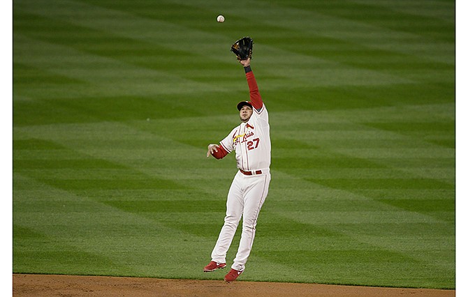 St. Louis Cardinals shortstop Jhonny Peralta makes a leaping catch on a ball hit by San Francisco Giants' Joe Panik during the first Game 1 of the National League baseball championship series Saturday, Oct. 11, 2014, in St. Louis. 