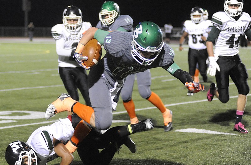 Mikel Drehle of Blair Oaks leaps over Warsaw defender during Friday night's game in Wardsville.