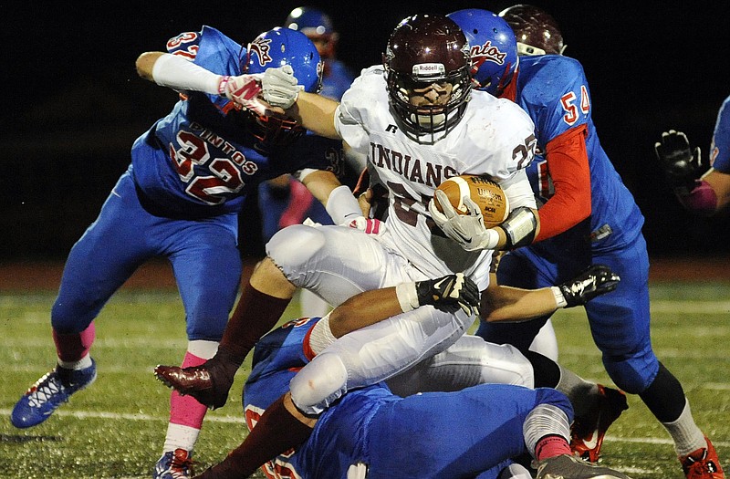 School of the Osage running back Jake Ulmer tries to spin through California tacklers during Friday night's game in California.