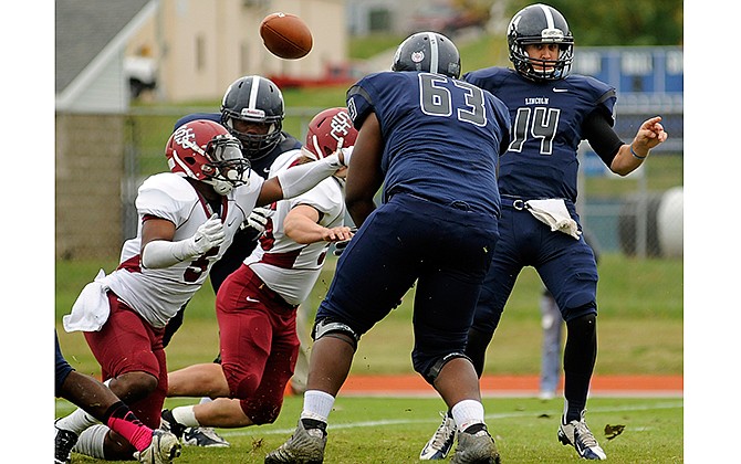 Lincoln University quarterback Owen Jordan (14) has the ball knocked away by St. Joseph's linebacker Wilky Orelien (5) during their football game Saturday at Dwight T. Reed Stadium in Jefferson City.